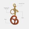 image:imageCOACH Bag CharmSmall Pretzel Bag Charm